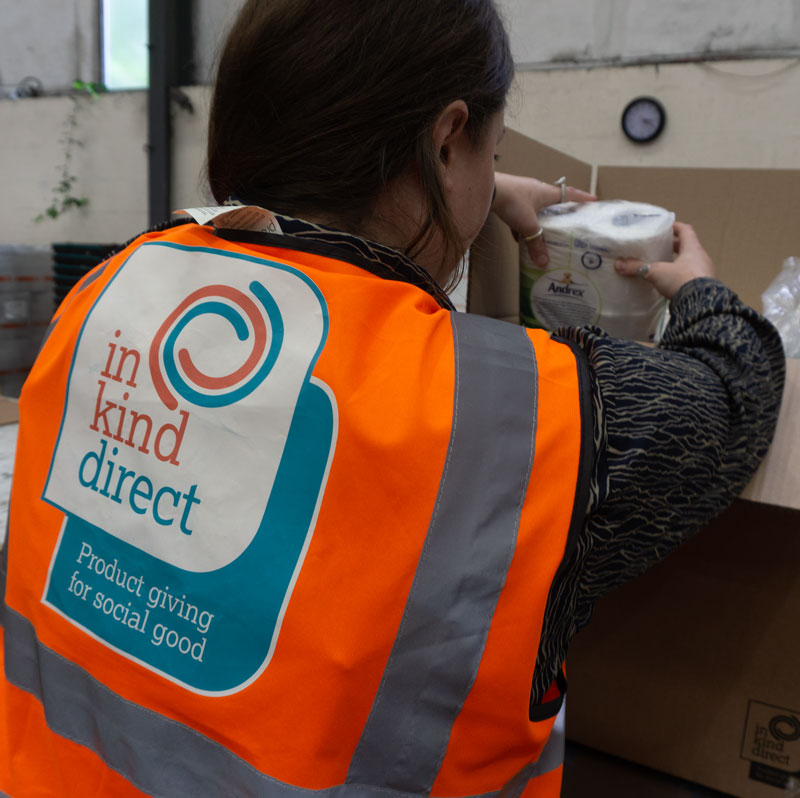 back of person packing a box of donations